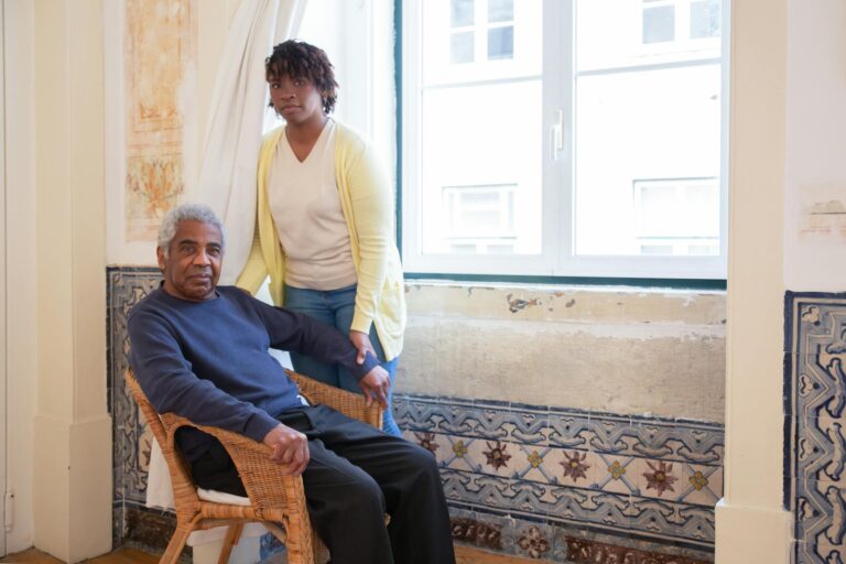 Elderly Man Sitting Beside Woman by the Window